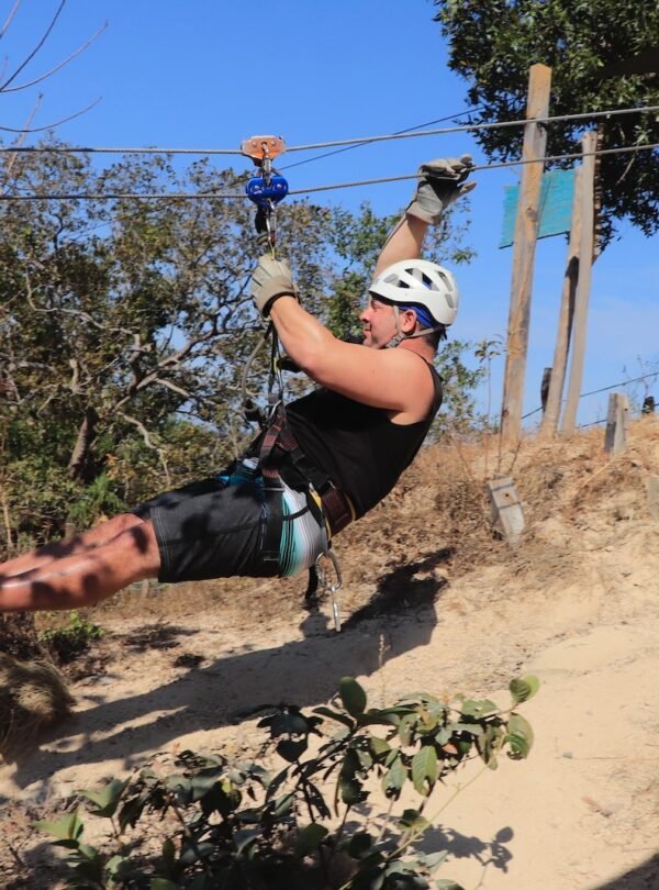 a man is zipping through the air on a rope
