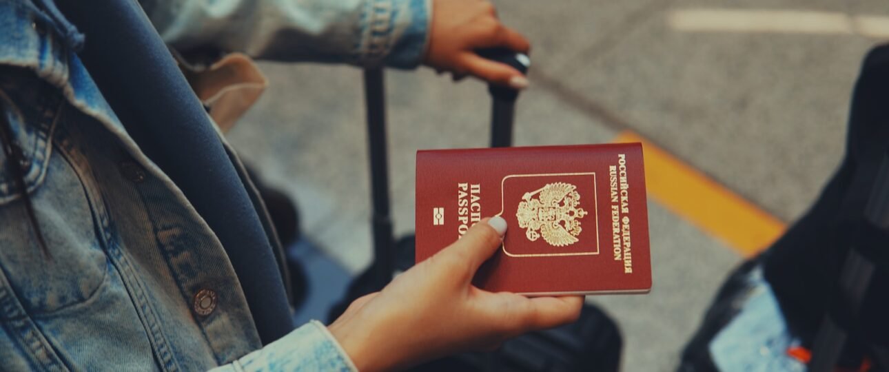 a person holding a red passport in their hand